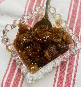 easy orange peel chutney in a small, square, glass container