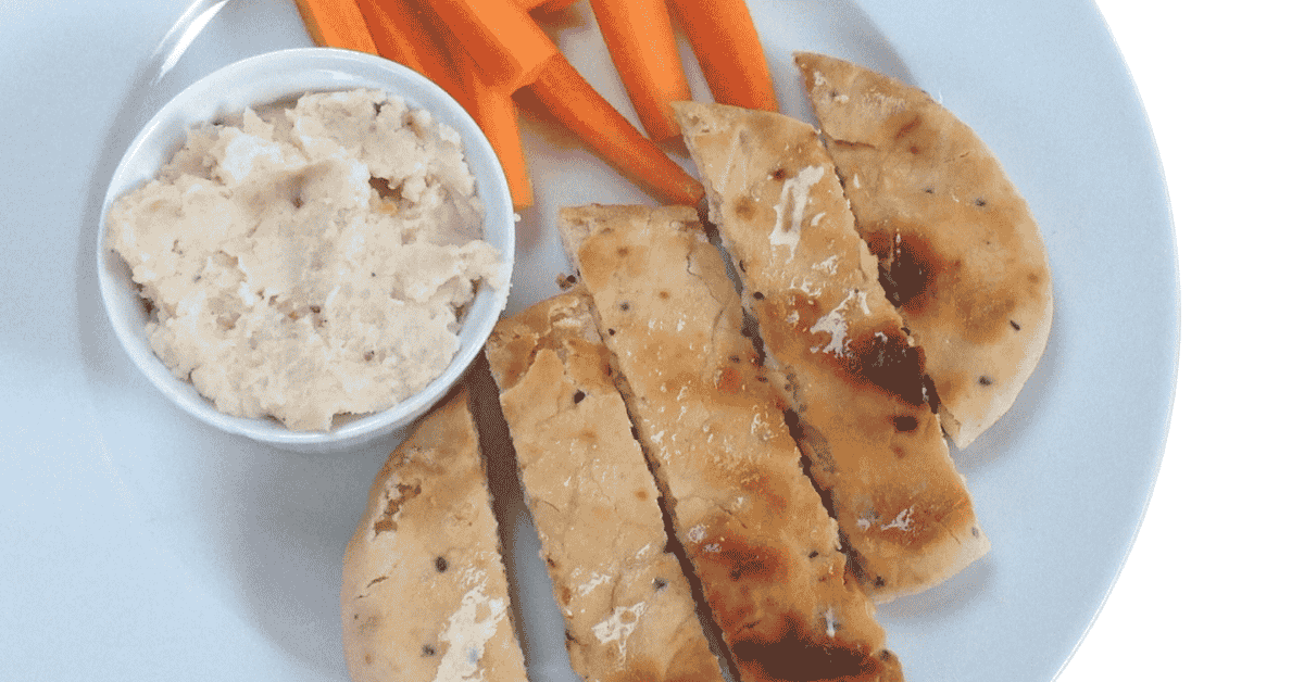 butterbean pate with carrots and pitta, on a white plate