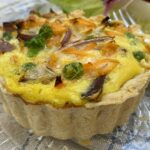 an individual mixed vegetable quiche