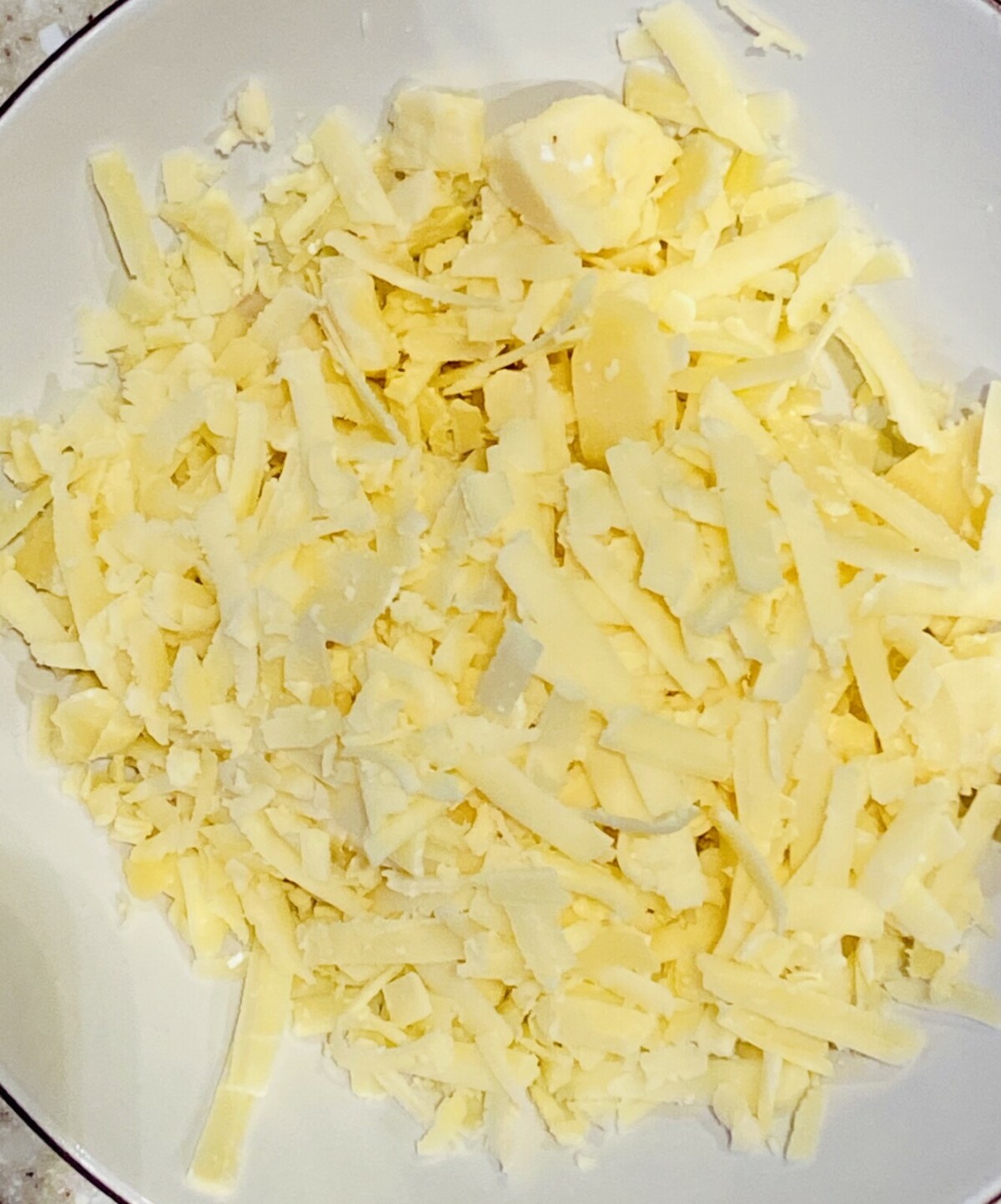 a dish of grated cheese