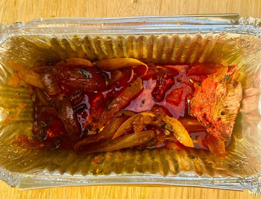 Indian takeaway container with a little left in it
