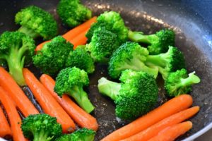 carrots and broccoli cooking for a vegetable puff pastry pie