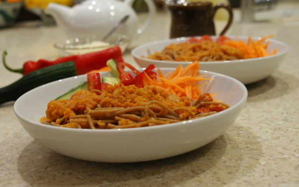 lentil ragu with spaghetti in a white bowl