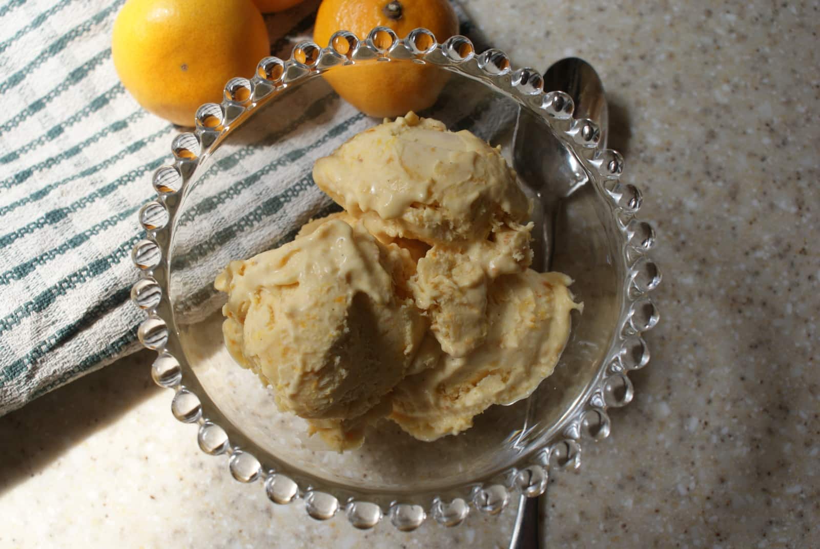 orange puree flavoured no churn ice cream in a glass bowl