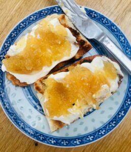 Lemon Peel Jam on toast with cream cheese, on blue patterned plate