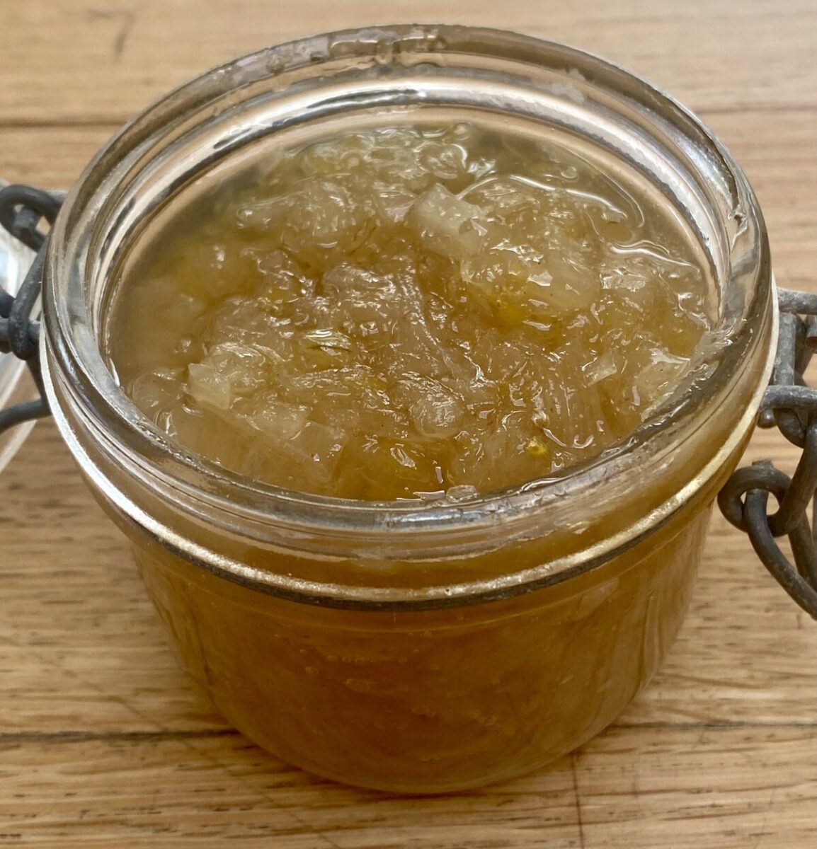 an open kilner jar of onion jam.