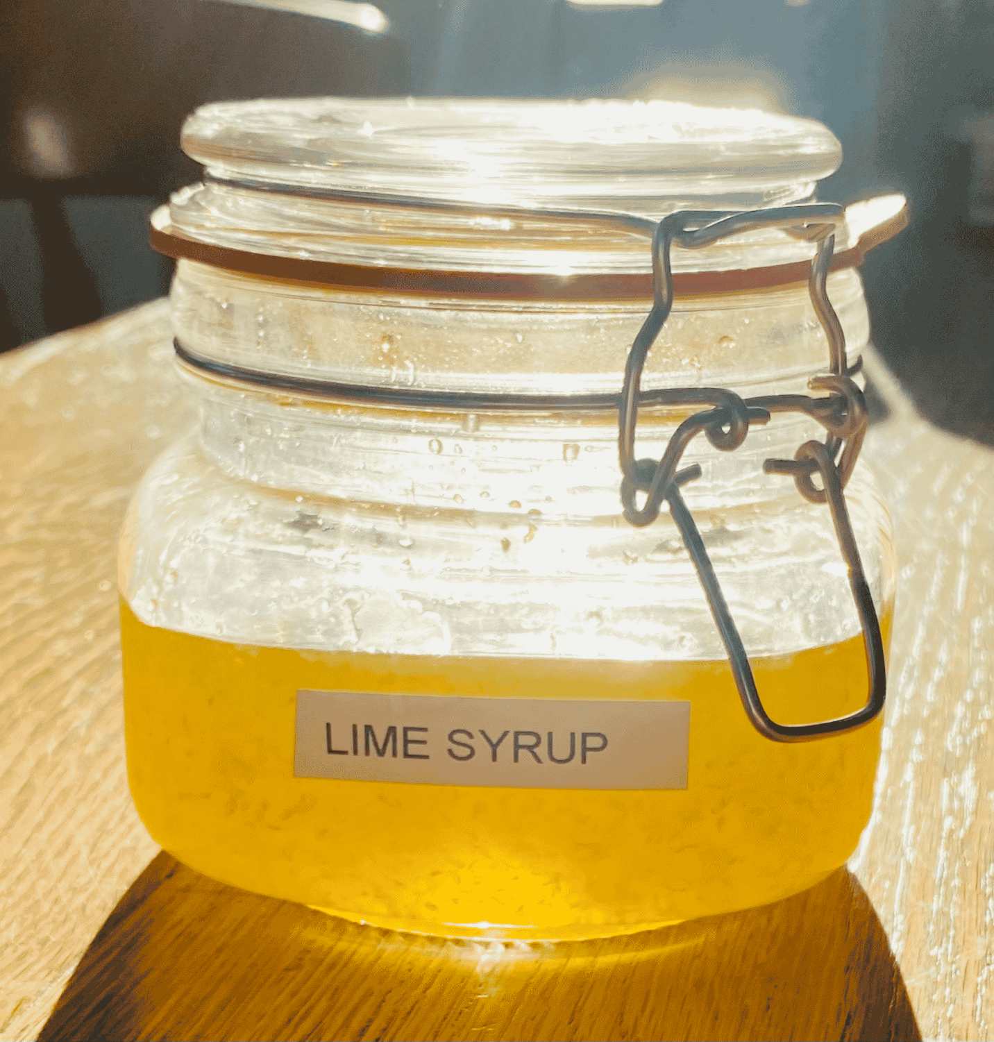 Fresh lime simple syrup in a glass clip top jar