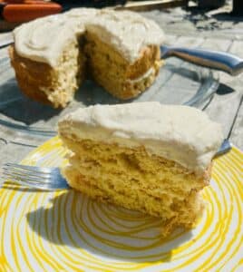orange peel cake with a slice on a yellow plate