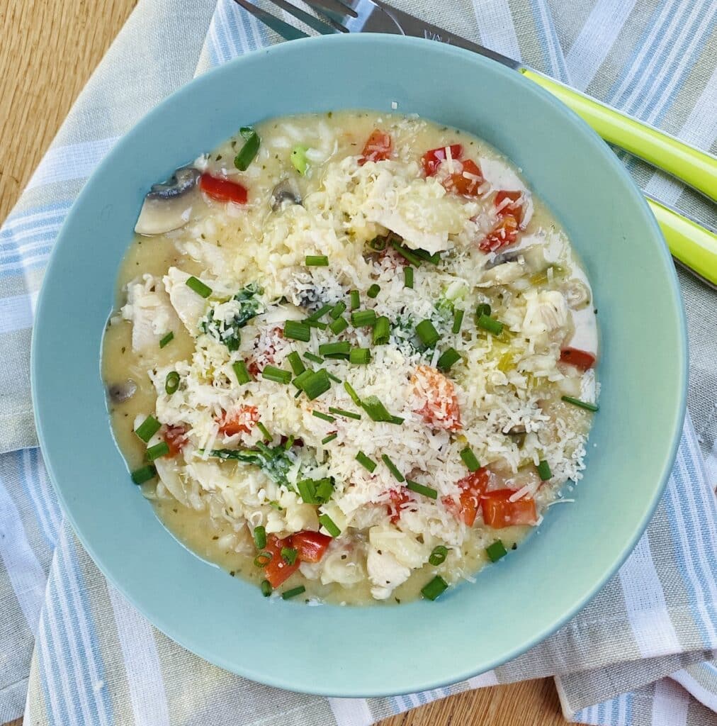 Risotto with leftover chicken in a blue bowl