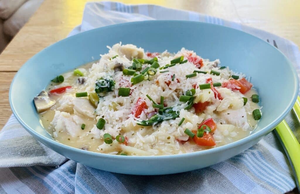 chicken and vegetable risotto in a blue bowl
