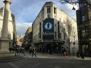 An outside shot of the Cambridge Theatre, London showing the promotion picture on Matilda