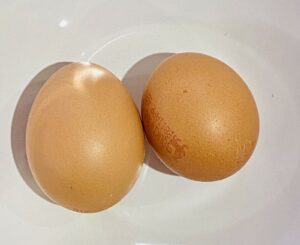 2 eggs in a white dish