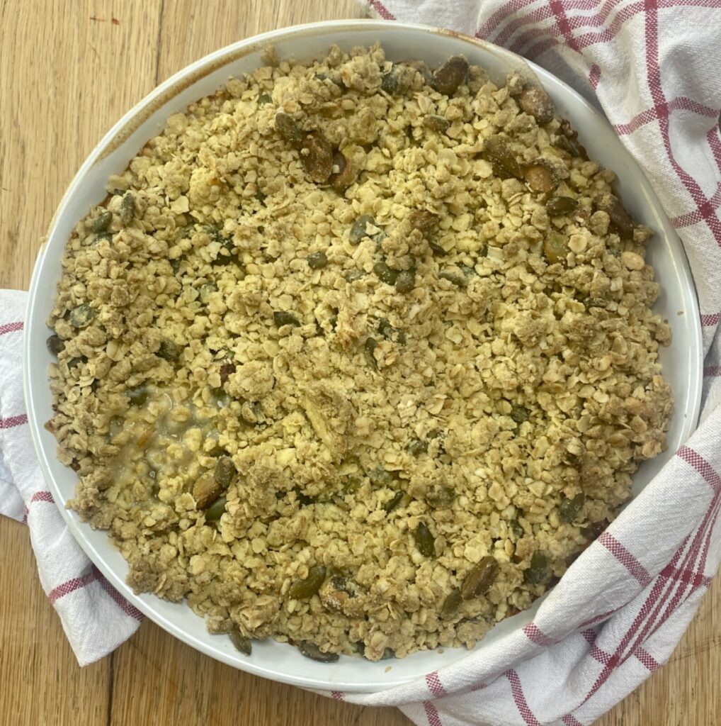 chicken and mushroom crumble, fresh from the oven, in a white dish.