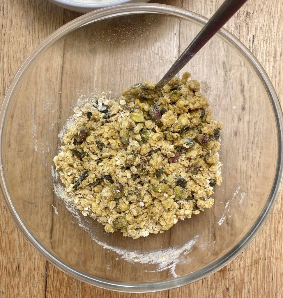 chicken and mushroom crumble topping mix in a glass bowl, with a spoon.