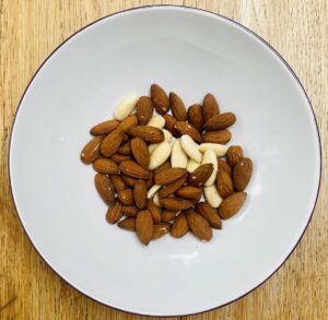 almonds in a bowl with a white inner.