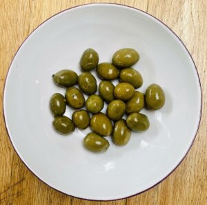olives in a bowl with a white inner.