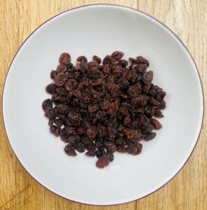 raisins in a bowl with a white inner.