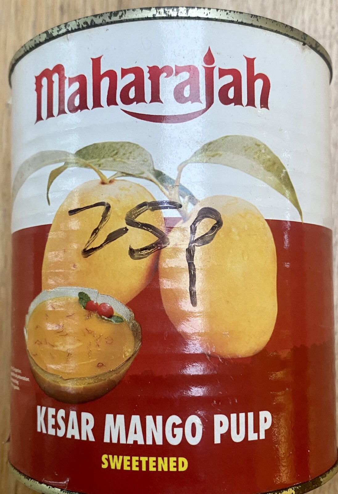 a tin of Kesar brand mango pulp, with 25p written on it by hand.