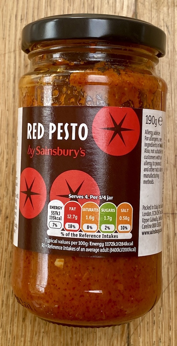 a glass jar of Sainsbury red pesto.
