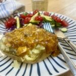 coronation chicken on a jacket potato with a mixed salad.