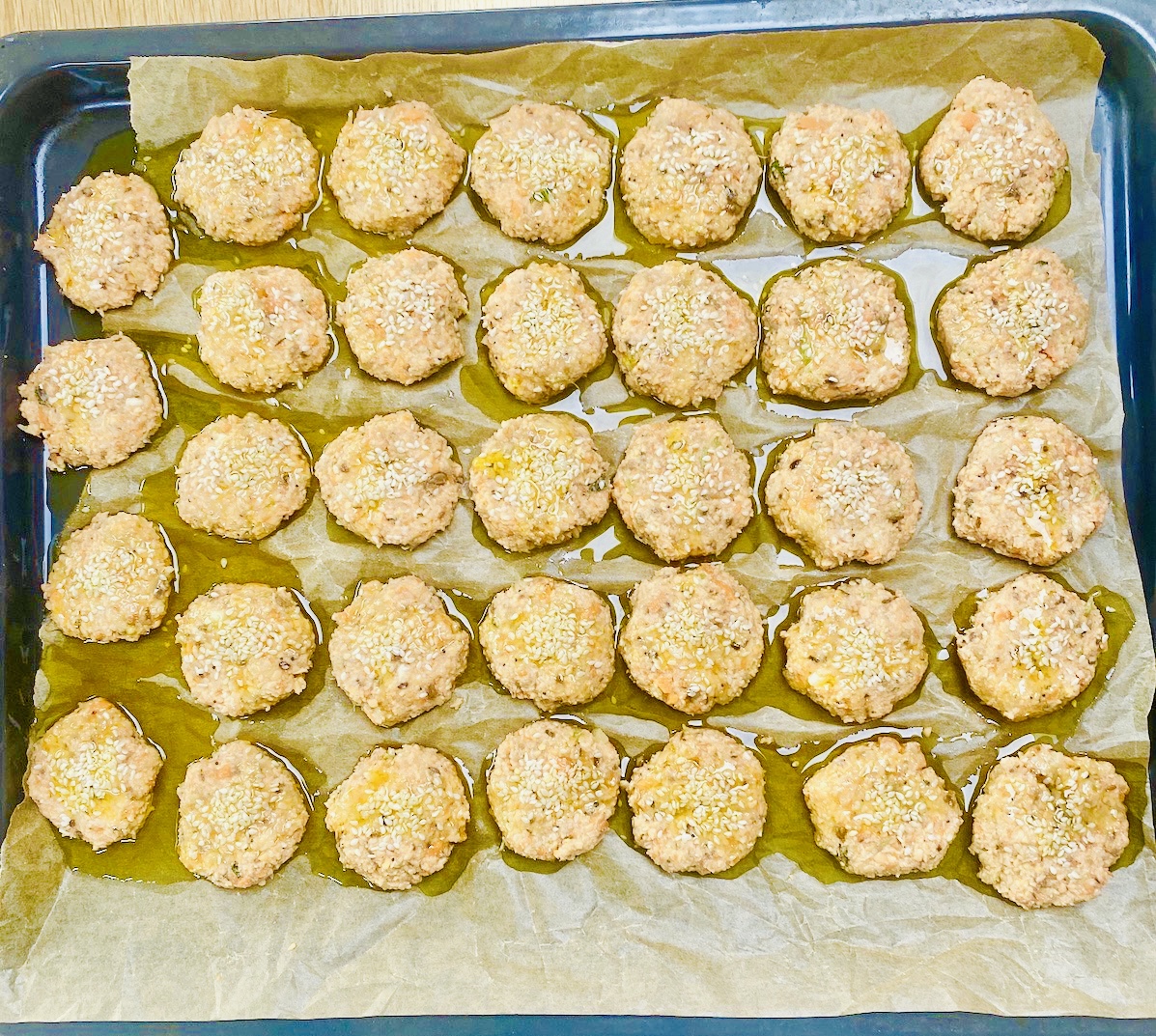 a tray of uncooked red lentil nuggets.