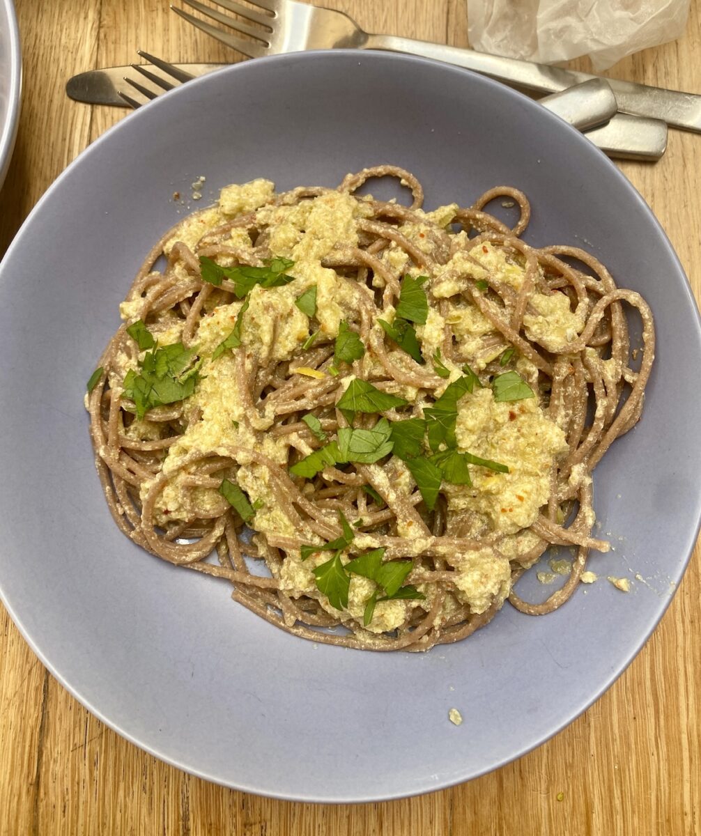 bowl of green tomato sauce and pasta.