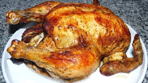 a roast chicken on a white platter