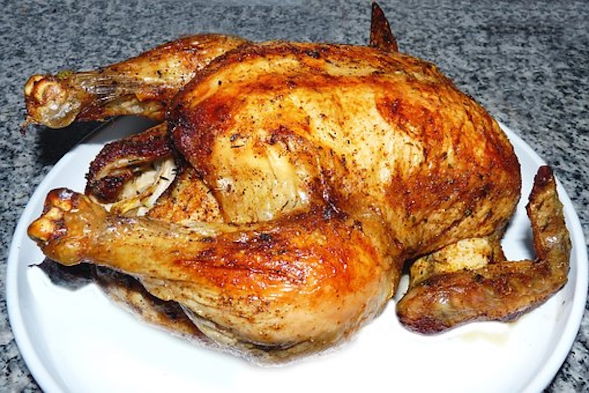 a roast chicken on a white platter