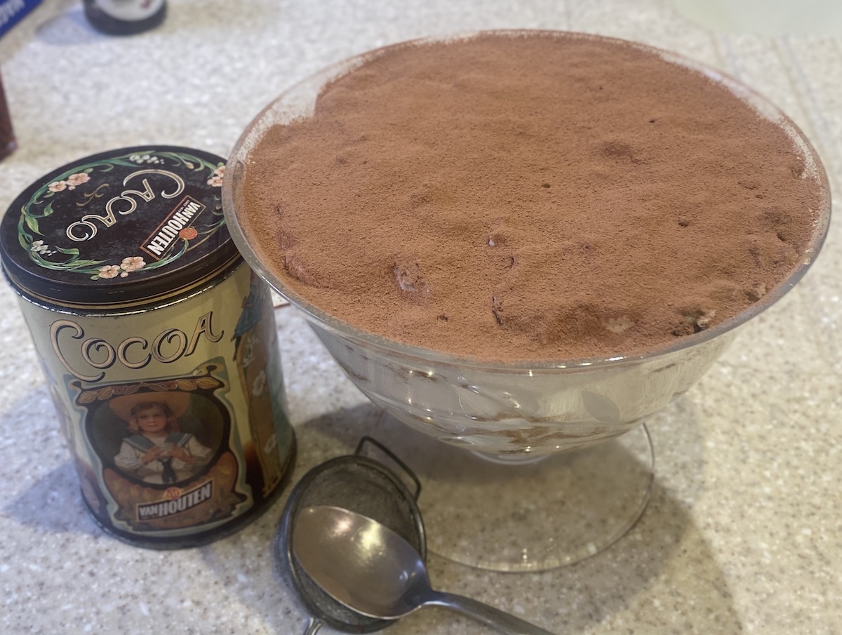 Panettone Tiramisu in a large glass bowl, with cocoa sieved over the top. 