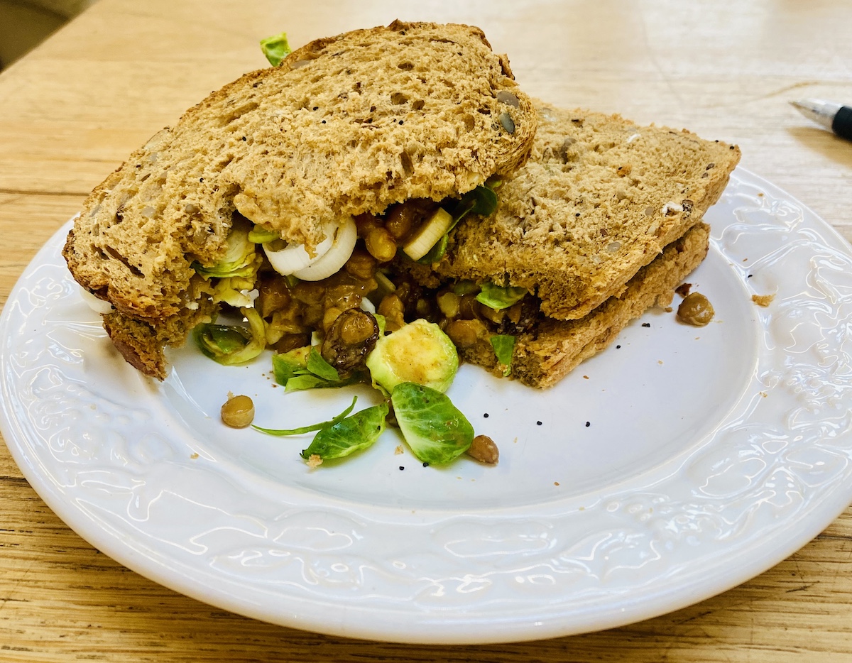 A Coronation lentil sandwich, half eaten. 