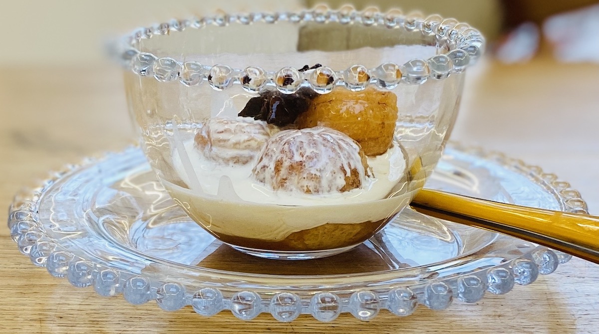 spiced clementines in a glass dish, on a glass plate and with a spoon. 