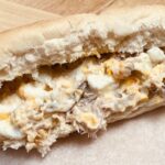 smoked mackerel sandwich filling in a white hotdog roll.