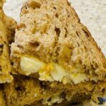 An egg mayonnaise sandwich, in quarters, using granary bread.