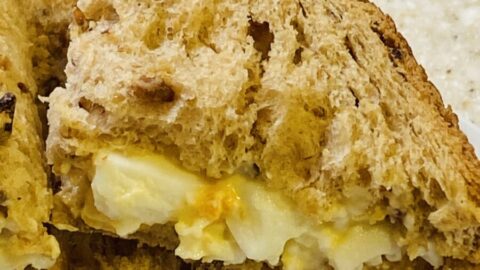 An egg mayonnaise sandwich, in quarters, using granary bread.