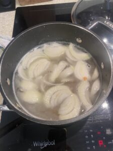 split pea soup simmering in a black saucepan.